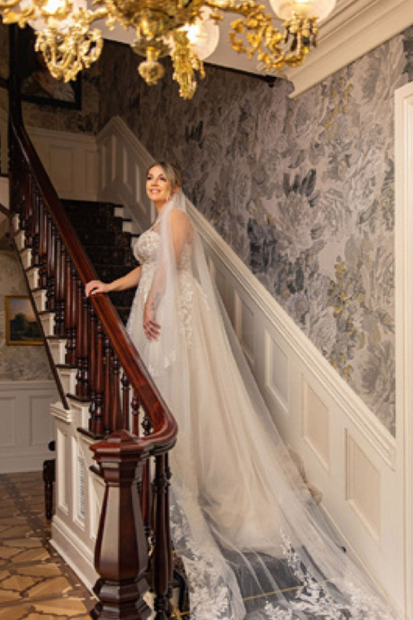 bride on staircase with wedding dress at William Mason House